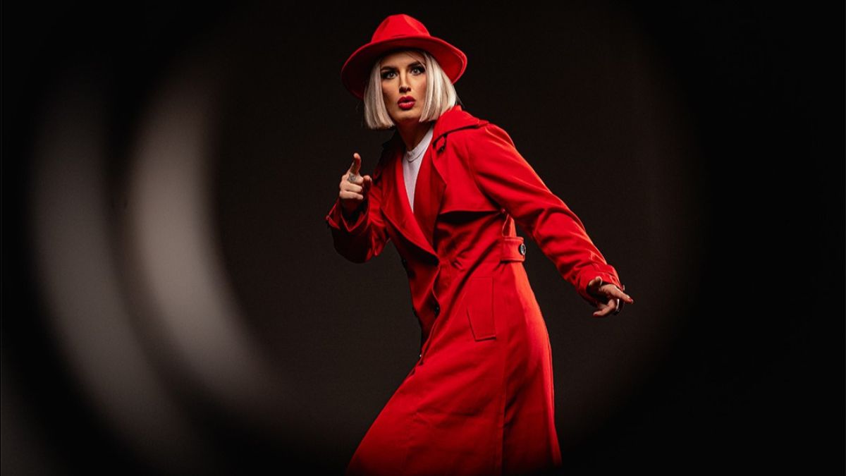 Toni Storm in her red coat and hat from AEW