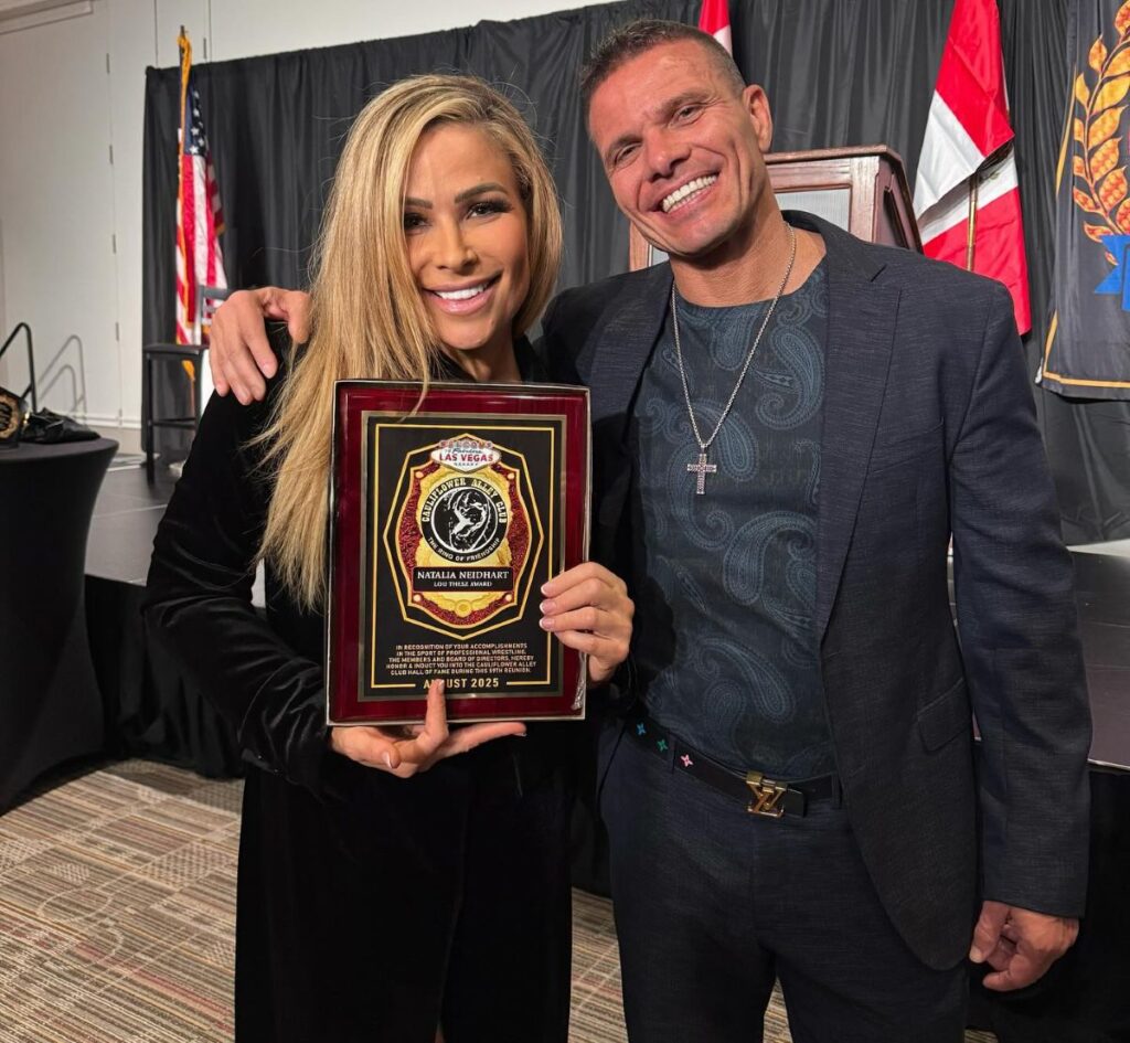 WWE's Natalya Lou Thesz Award winner next to TJ Wilson