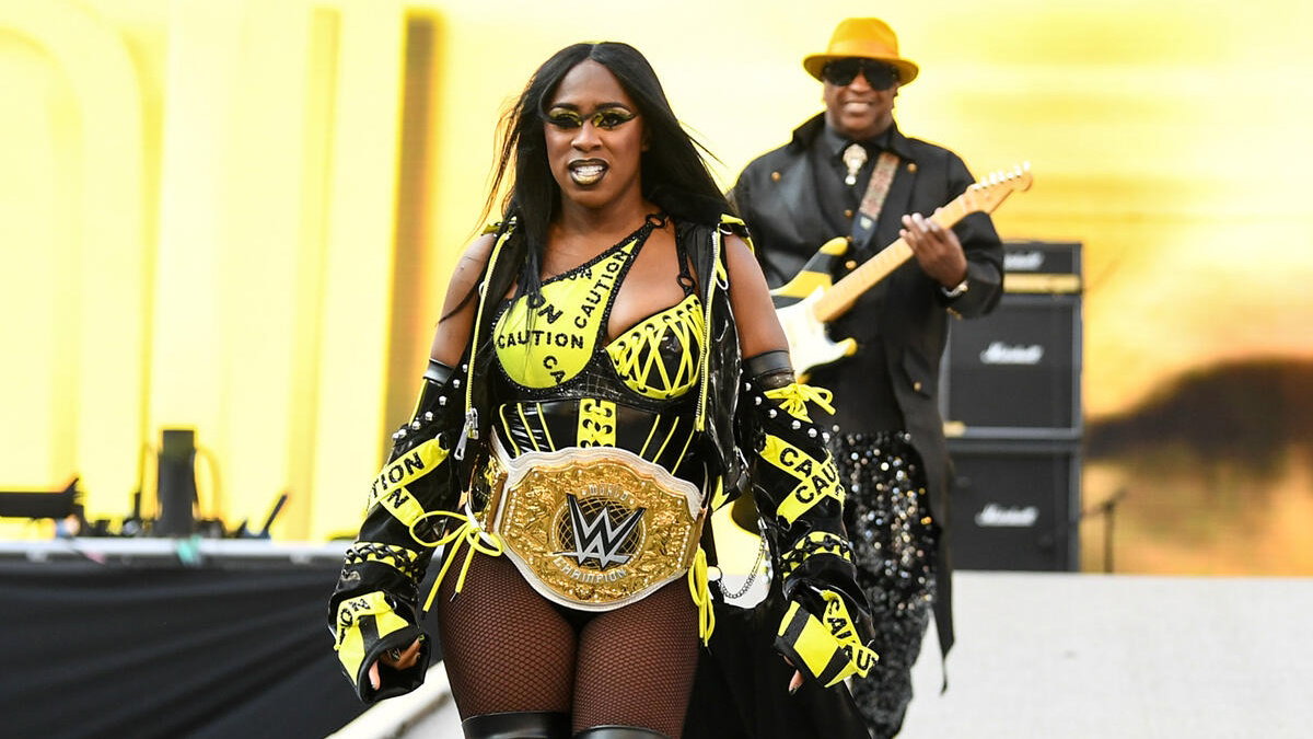 WWE star Naomi entrance with her Dad, a guitarist behind her