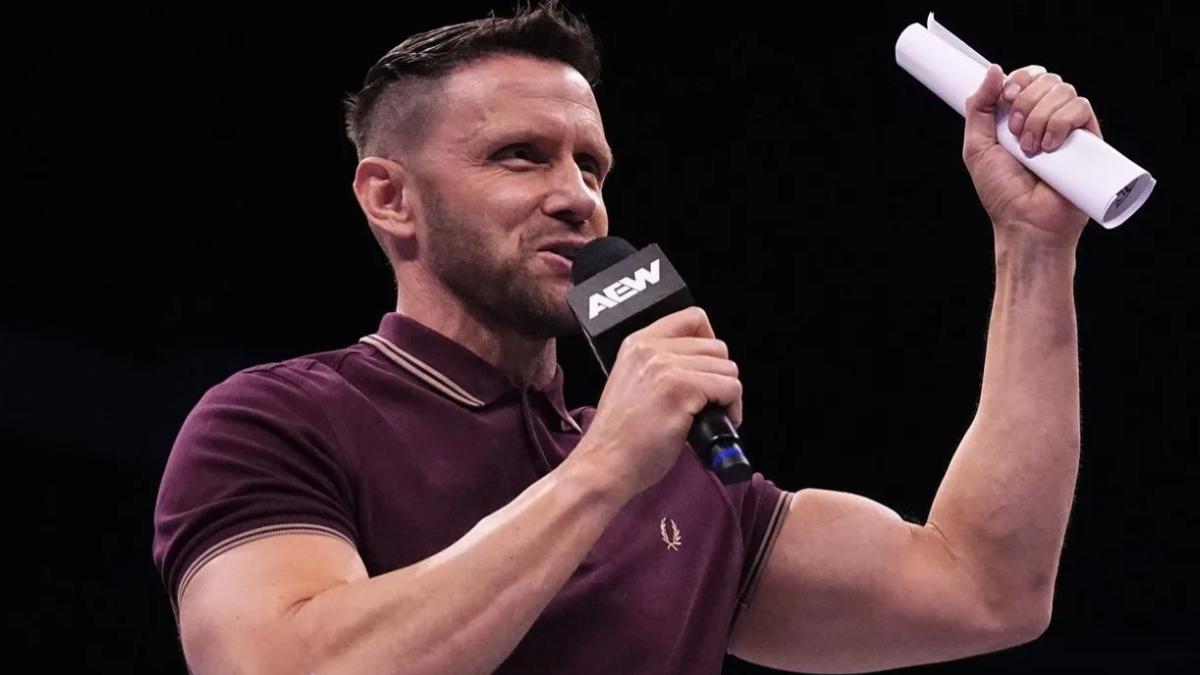 AEW's Nigel McGuinness holding a contract