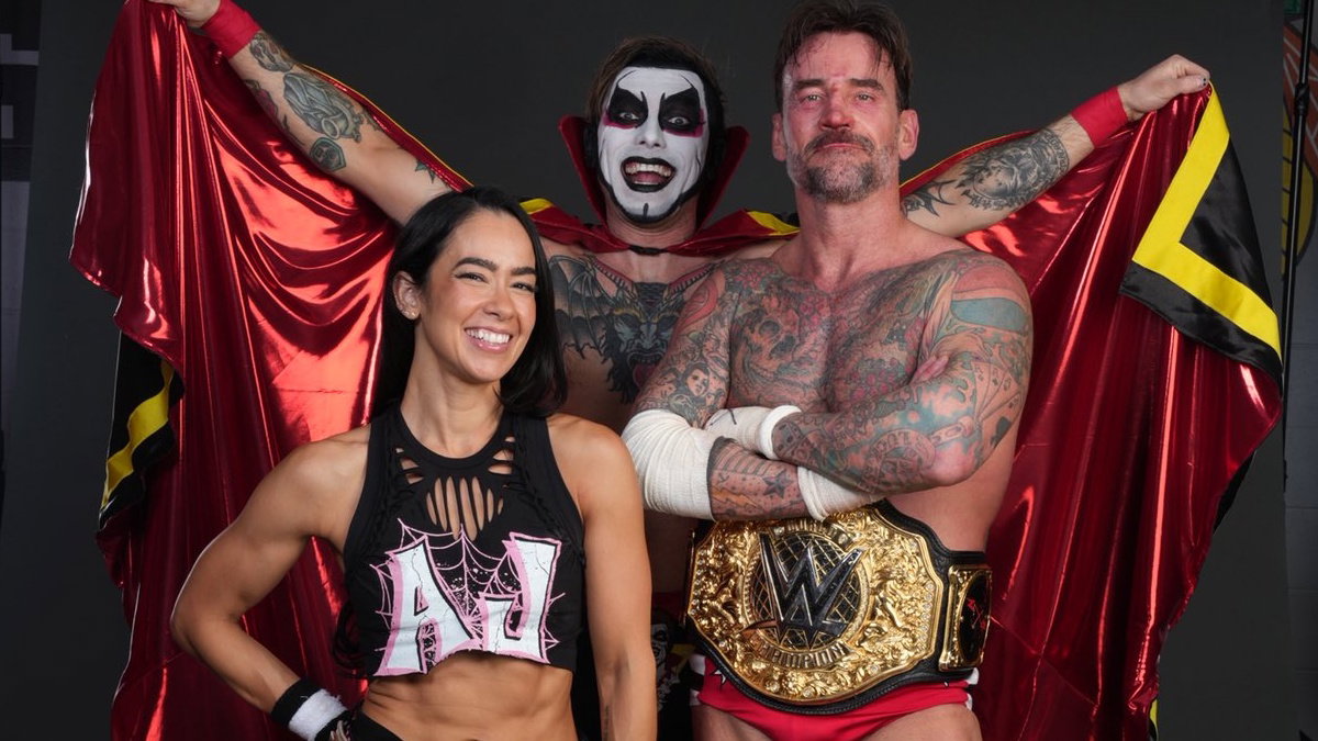 Danhausen behind CM Punk & AJ Lee in WWE