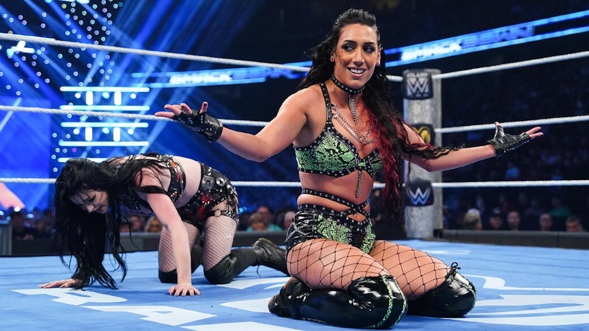 WWE star Jacy Jayne with Paige behind her in wrestling ring